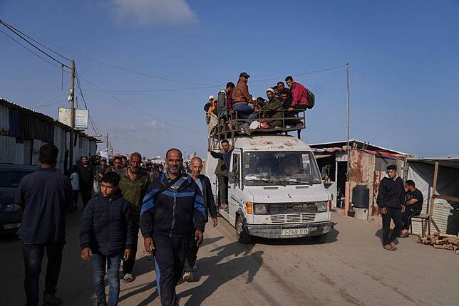 Moving on a vehicle, Palestinians transport humanitarian aid bags delivered by the Gaza Humanitarian Foundation, a U.S.-backed organization approved by Israel, in Khan Younis, southern Gaza Strip, Sunday, June 1, 2025. (AP Photo/Abdel Kareem Hana)