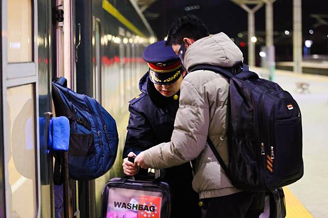 Geru Tseten &reg; boards a train at the Xining Railway Station in Xining, northwest China's Qinghai Province in February 2025. (China Railway Qinghai-Xizang Group Co., Ltd./Handout via Xinhua)