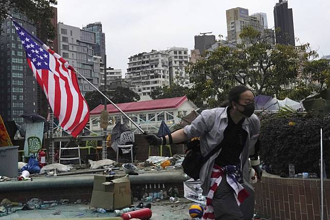 A protester carries an American flag at Hong Kong Polytechnic University on November 20. Photo: AP