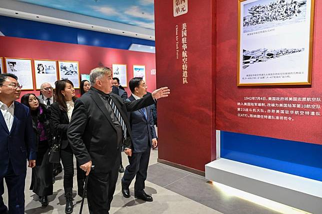 A delegation of the Sino-American Aviation Heritage Foundation visit a photo exhibition dedicated to the Flying Tigers in Urumqi, capital of northwest China's Xinjiang Uygur Autonomous Region, Nov. 30, 2024. (Xinhua/Ding Lei)