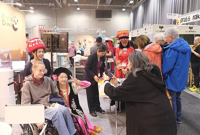 People pose for photos at &ldquo;Hello, China!&rdquo; booth in Norway's largest travel fair TravelXpo in Lillestrom, Norway, on Jan. 10, 2025. (Xinhua/Zhang Yuliang)