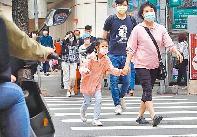 靖娟基金會「2023年台灣兒童安全指標」調查指出，兒童給「交通安全」最低分。圖為路口常見家長擔心交通亂象，手牽著小朋友過馬路。（姚志平攝）