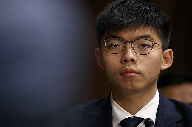Speaking against the decision, Joshua Wong says on Facebook it is inappropriate for the court to comment on how politicians should behave. Photo: AP