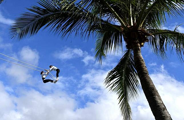 Athletes compete during the swing competition at the 12th National Traditional Games of Ethnic Minorities of China in Sanya, south China's Hainan Province, Nov. 24, 2024. (Xinhua/Wang Xiao)