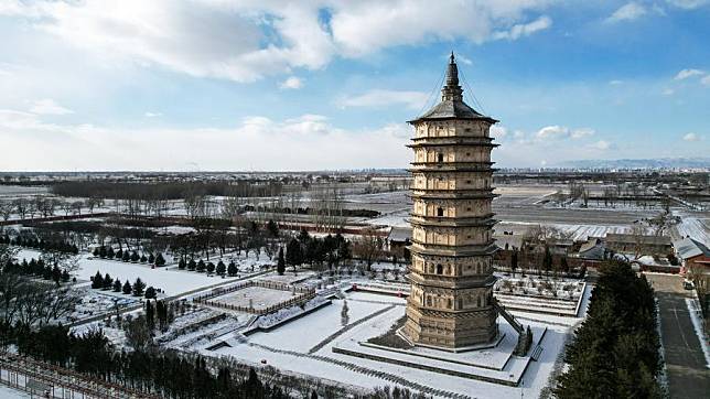 An aerial drone photo taken on Dec. 20, 2024 shows the White Pagoda in Saihan District of Hohhot City, north China's Inner Mongolia Autonomous Region. (Xinhua/Li Zhipeng)