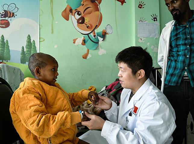 Chinese doctor Ren Yuwei, a member of the 25th Chinese medical team dispatched to Ethiopia, examines a young patient at the ward of the Tirunesh Beijing General Hospital in Addis Ababa, Ethiopia, Feb. 14, 2025. (Xinhua/Han Xu)