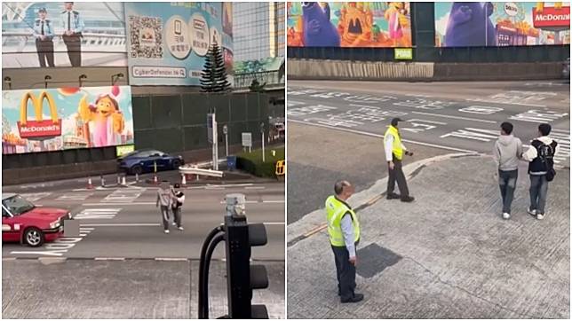 兩男在紅隧出口過馬路要職員帶走。(網片截圖)