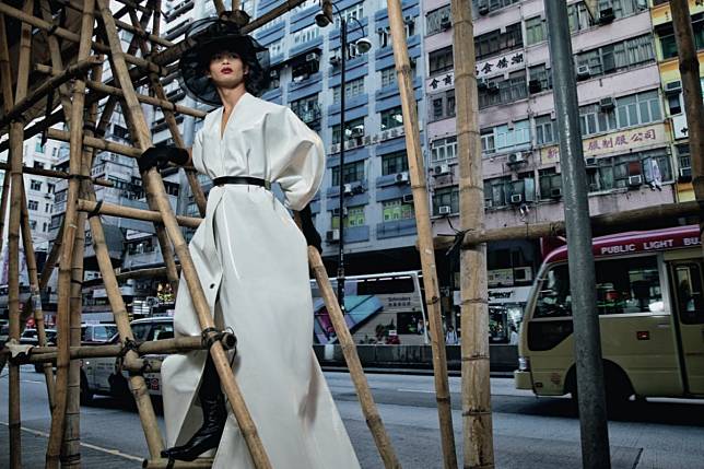 In Hong Kong, Lu models the white tarpaulin dress that made him famous. Photo: Elle via Goldthread