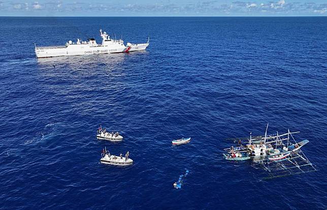 An aerial drone photo taken on June 29, 2024 shows the China Coast Guard assisting injured Filipino fishermen in waters adjacent to China's Huangyan Dao. (Xinhua/Deng Hua)