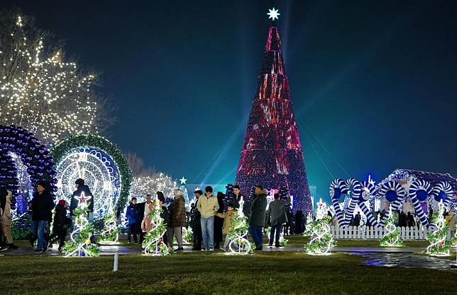 People visit a light show in celebration of the New Year in Tashkent, Uzbekistan, Dec. 31, 2024. (Photo by Zafar Khalilov/Xinhua)