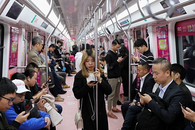 A female passenger surrounded by men in a priority carriage on the Shenzhen metro. Photo: Sam Tsang