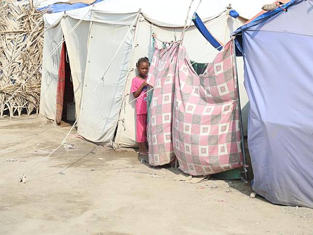 A girl stands by a tent at a center for displaced people fleeing from conflict between the Sudanese Armed Forces and the paramilitary Rapid Support Forces in Port Sudan, Red Sea State, eastern Sudan, on Nov. 12, 2024. (Xinhua/Fayez Ezaki)