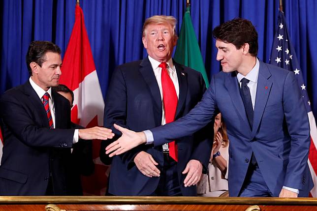 Mexican President Enrique Pena Nieto and Canadian Prime Minister Justin Trudeau shake hands while US President Donald Trump looks on at a 2018 signing ceremony for the United States-Mexico-Canadian Agreement. A Pew Research Centre survey shows sentiment toward the US is decidedly mixed. Photo: Reuters