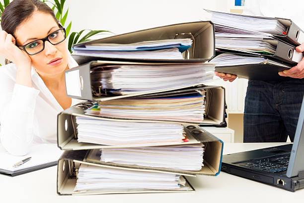 overworked secretary drowning in paperwork