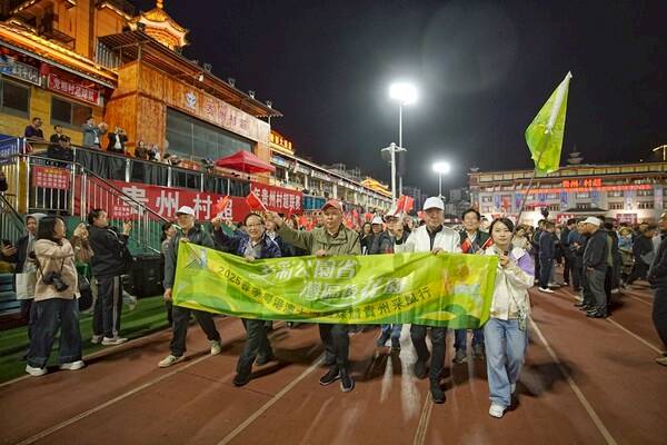 Visiting journalists join the player parade, rallying behind Village Super League’s amateur athletes.