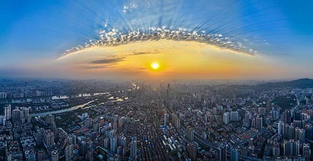 An aerial drone photo taken on March 12, 2024 shows the city view at sunset in Guangzhou, south China's Guangdong Province. (Xinhua/Liu Dawei)