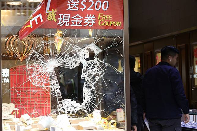 The front window of the Fook Tai jewellery store on Castle Peak Road was smashed during Monday’s raid. Photo: May Tse