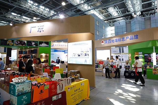 People visit booths of geographical indication products at the 13th China Intellectual Property Annual Conference in Beijing, China, Sept. 14, 2024. (Photo by Liu Shuyan/Xinhua)