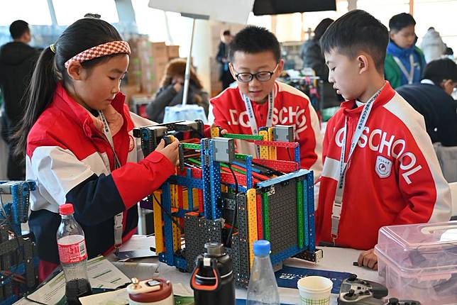 Young contestants debug their robots during the World Robot Contest Finals 2023 in Fusong County, Baishan City, northeast China's Jilin Province, Jan. 26, 2024. (Xinhua/Song Xinping)