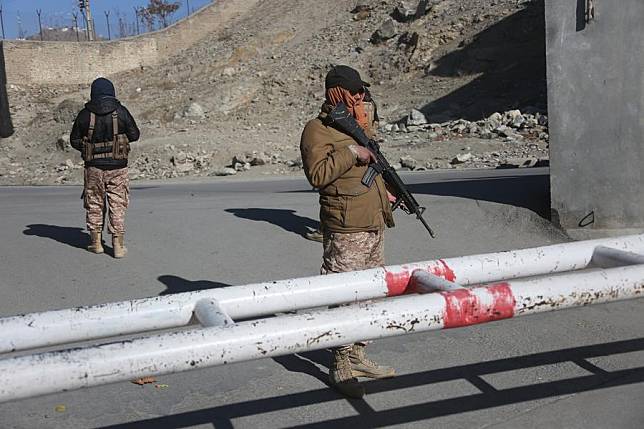 Security force members are seen outside the gate of the ministry for refugees and repatriation of the Afghan caretaker government in Kabul, Afghanistan, Dec. 12, 2024. (Photo by Saifurahman Safi/Xinhua)