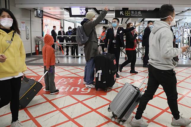 Some entrances to West Kowloon station were closed as passengers raced to get on a train before services were halted. Photo: Nora Tam