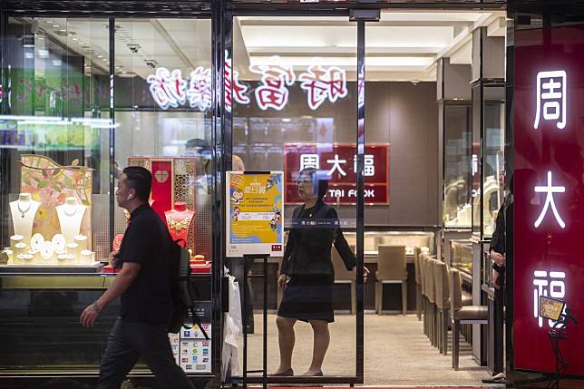 It can be a bit lonely these days as a retail clerk. Here, an employee stands at the door of a Chow Tai Fook Jewellery Group store in the Causeway Bay district of Hong Kong on August 29, 2019. Photo: Bloomberg