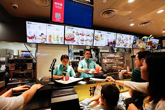 Customers line up for chicken a KFC restaurant in Beijing. Photo: Shutterstock Images