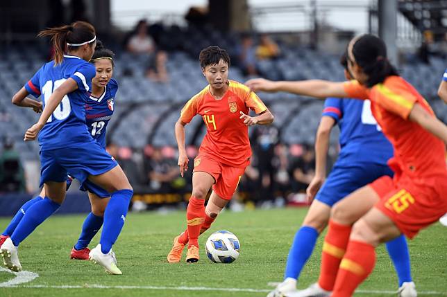 China’s Zhang Linyan (in red) dribbles the ball during the Olympic football tournament qualifying group match against Taiwan at Campbelltown Stadium in Sydney. Photo: AFP