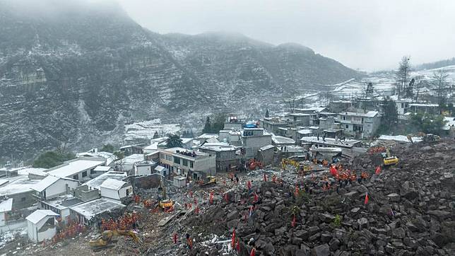 An aerial drone photo shows rescuers working at the site of a landslide in Liangshui Village, Tangfang Town in the city of Zhaotong, southwest China's Yunnan Province, Jan. 23, 2024. (Xinhua/Hu Chao)