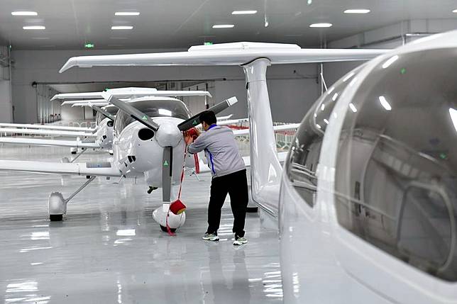 A staff member assembles an aircraft at a hangar of a high-tech industrial park in Binzhou, east China's Shandong Province, Oct. 9, 2024. (Xinhua/Guo Xulei)