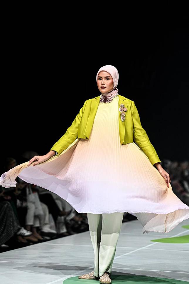 A model presents a creation from Hijabchic during Jakarta Muslim Fashion Week (JMFW) 2025 in Tangerang, Banten Province, Indonesia, on Oct. 10, 2024. (Xinhua/Agung Kuncahya B.)