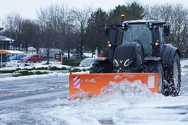 A snow plough clears a car park in Manchester, Britain, on Jan. 5, 2025.(Photo by Jon Super/Xinhua)