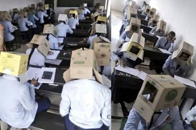 印度學校考試時為了防止作弊，學生們頭上竟都戴著紙箱。(圖擷自@Sain_Mushahid推特)