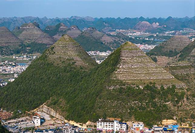 An aerial photo taken on May 14, 2024 shows a view of pyramid-shaped hills in Anlong County, southwest China's Guizhou Province. Several hills that resemble the pyramids of Egypt in a suburb of Anlong have recently become a popular tourist attraction. It appears that these hills are made of parallel layers of stones. (Xinhua/Liu Xu)