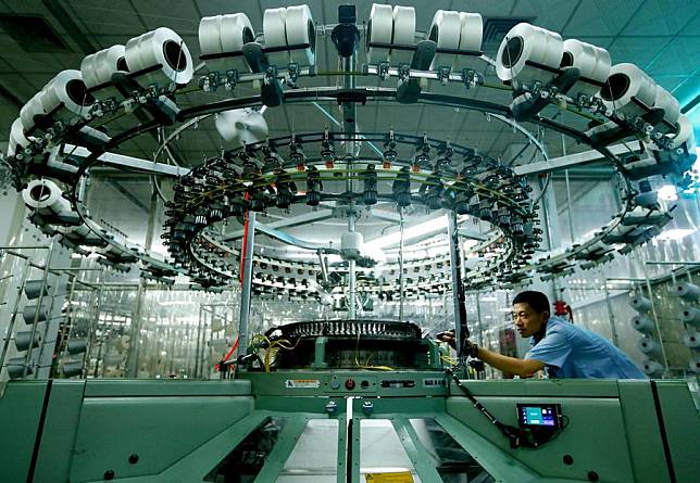 A worker is pictured at the production line of a textile company in Jimo District of Qingdao City, east China's Shandong Province, Oct. 7, 2024. (Photo by Liang Xiaopeng/Xinhua)