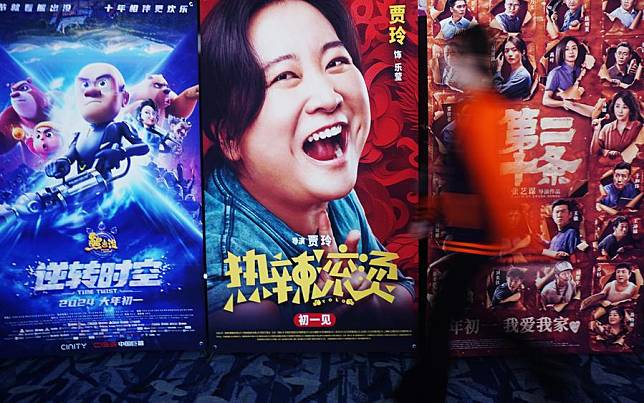 A citizen walks past movie posters at a cinema in Hangzhou City, east China's Zhejiang Province, Feb. 16, 2024. (Photo by Long Wei/Xinhua)