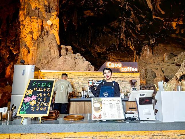 A barista shows a cup of coffee at a cave-themed café in Fumin County of Kunming, southwest China's Yunnan Province, March 16, 2024. (Xinhua/Ji Zhepeng)