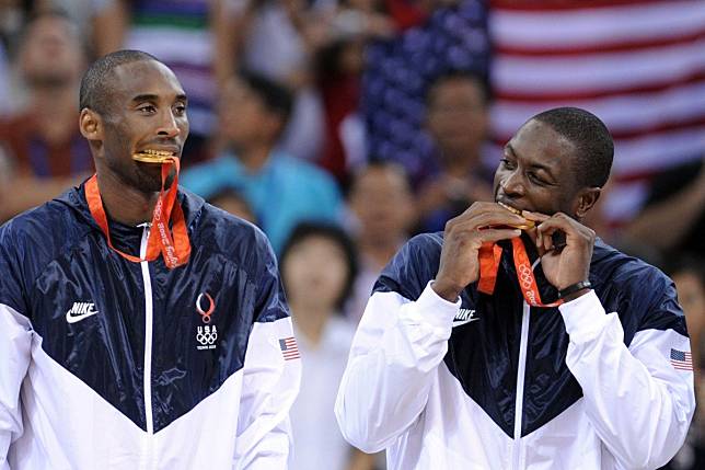 Team USA's Kobe Bryant and Dwyane Wade bite their gold medals on the podium at the Beijing 2008 Olympic Games. Photo: AFP