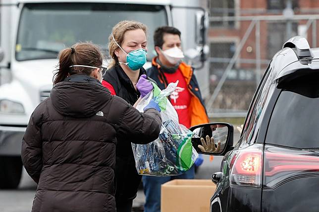 A woman makes a donations during the Personal Protective Equipment drive in Chicago, Illinois. Photo: AFP
