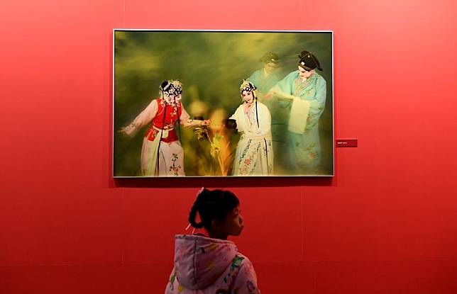 A girl visits a photo exhibition of the 15th China Photography Festival in Sanmenxia City, central China's Henan Province, Nov. 23, 2024. The festival opened here on Saturday. (Xinhua/Zhu Xiang)