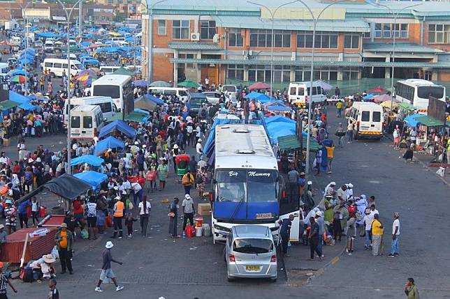 People and vehicles are seen at the Francistown Bus Rank in Francistown, Botswana, on Dec. 24, 2024. (Photo by Shingirai Madondo/Xinhua)