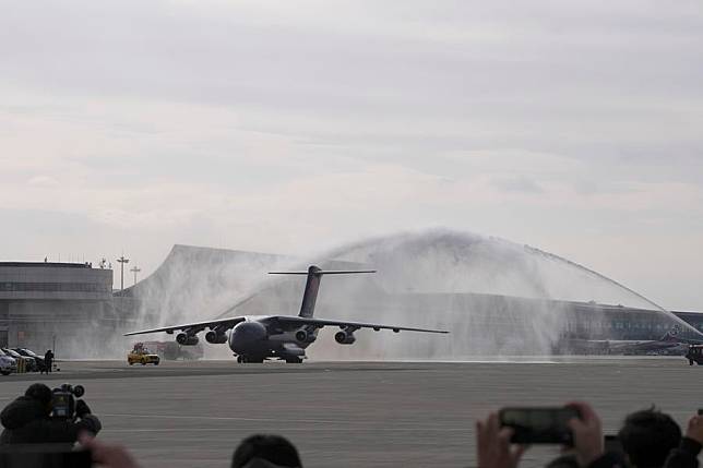 A military aircraft carrying the remains of Chinese People's Volunteers (CPV) martyrs is honored with a water salute after landing at the Taoxian international airport in Shenyang, northeast China's Liaoning Province, Nov. 28, 2024. (Xinhua/Li Gang)