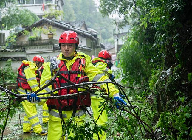 Firefighter chief Cheng Shunfu (front) and his team members remove branches at ancient Tunxi street at Tunxi District of Huangshan City, east China's Anhui Province, June 26, 2024. (Xinhua/Fu Tian)