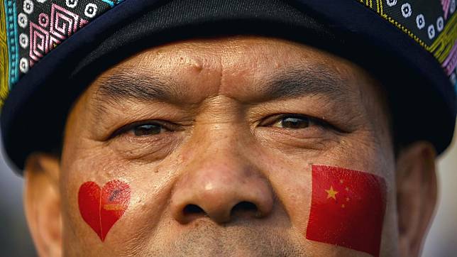 An attendee in ethnic minority dress at the parade commemorating the 70th birthday of Communist China in October.