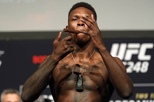 UFC middleweight champion Israel Adesanya poses on the scale during a ceremonial weigh-in for UFC 248. Photo: AP