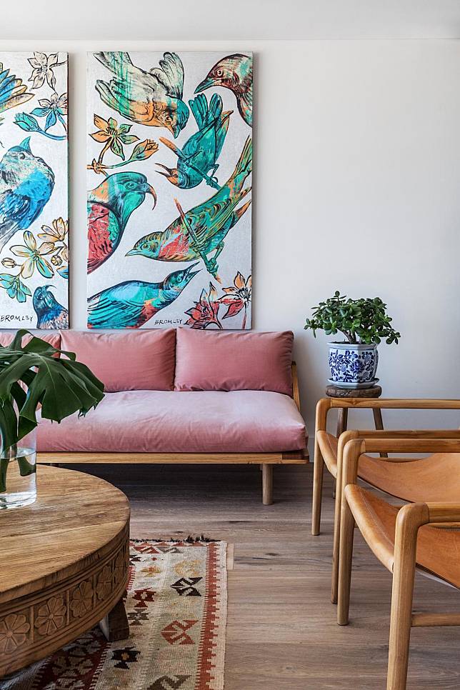 Vibrant paintings and brightly hued furnishings enliven the living areas