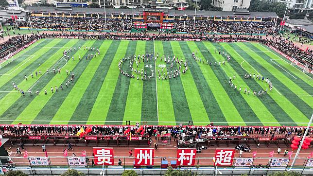 An aerial drone photo taken on Jan. 4, 2025 shows the dancers performing at halftime during the opening game at the Village Super League 2025 in Rongjiang County of southwest China's Guizhou Province. (Xinhua/Yang Wenbin)