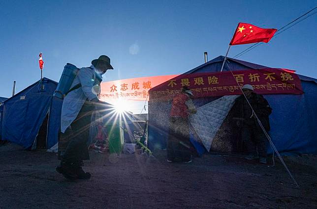 A villager carries out disinfection at a temporary resettlement site in Naicun Village, Dinggye County of Xigaze, southwest China's Xizang Autonomous Region, Jan. 10, 2025. (Xinhua/Tenzin Nyida)