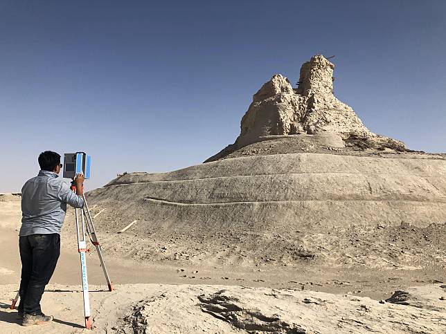 This file photo taken on Oct. 20, 2020 shows a member of cultural relics protection staff creating digital file with a 3-D laser scanner for the ruins of a stupa at the Loulan Ruins in the wilderness of Ruoqiang County, northwest China's Xinjiang Uygur Autonomous Region. (Northwest Research Institute Co., Ltd. of CREC/Handout via Xinhua)