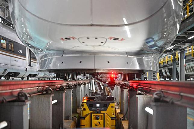 A robot inspects the bottom of a bullet train at a high-speed train maintenance base in Beijing, capital of China, Dec. 19, 2024. The Beijing-Zhangjiakou high-speed railway went into operation on Dec. 30, 2019 and will mark its fifth anniversary soon. (Xinhua/Sun Ruibo)